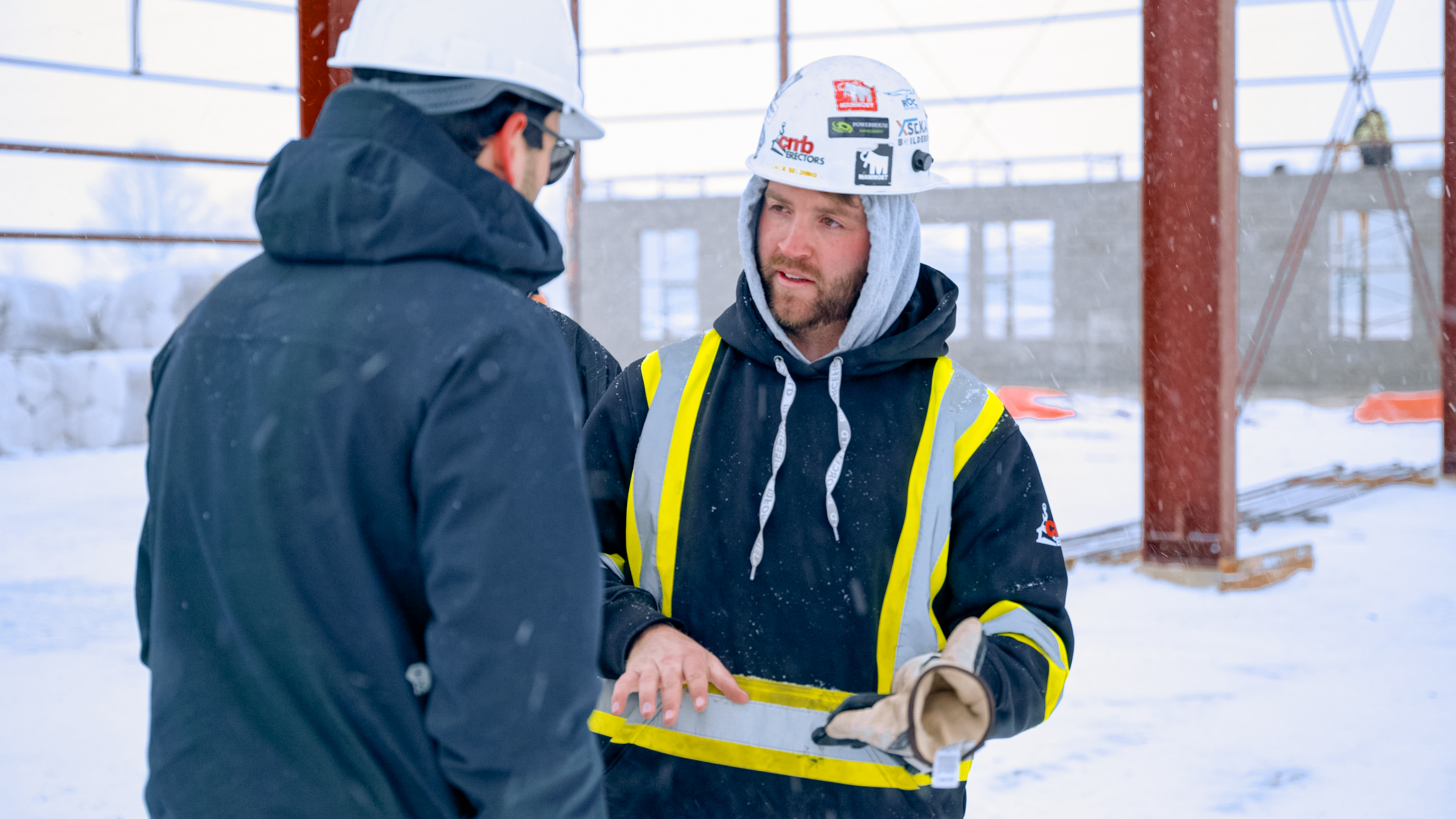 Foreman talking with a colleague on a steel erection site